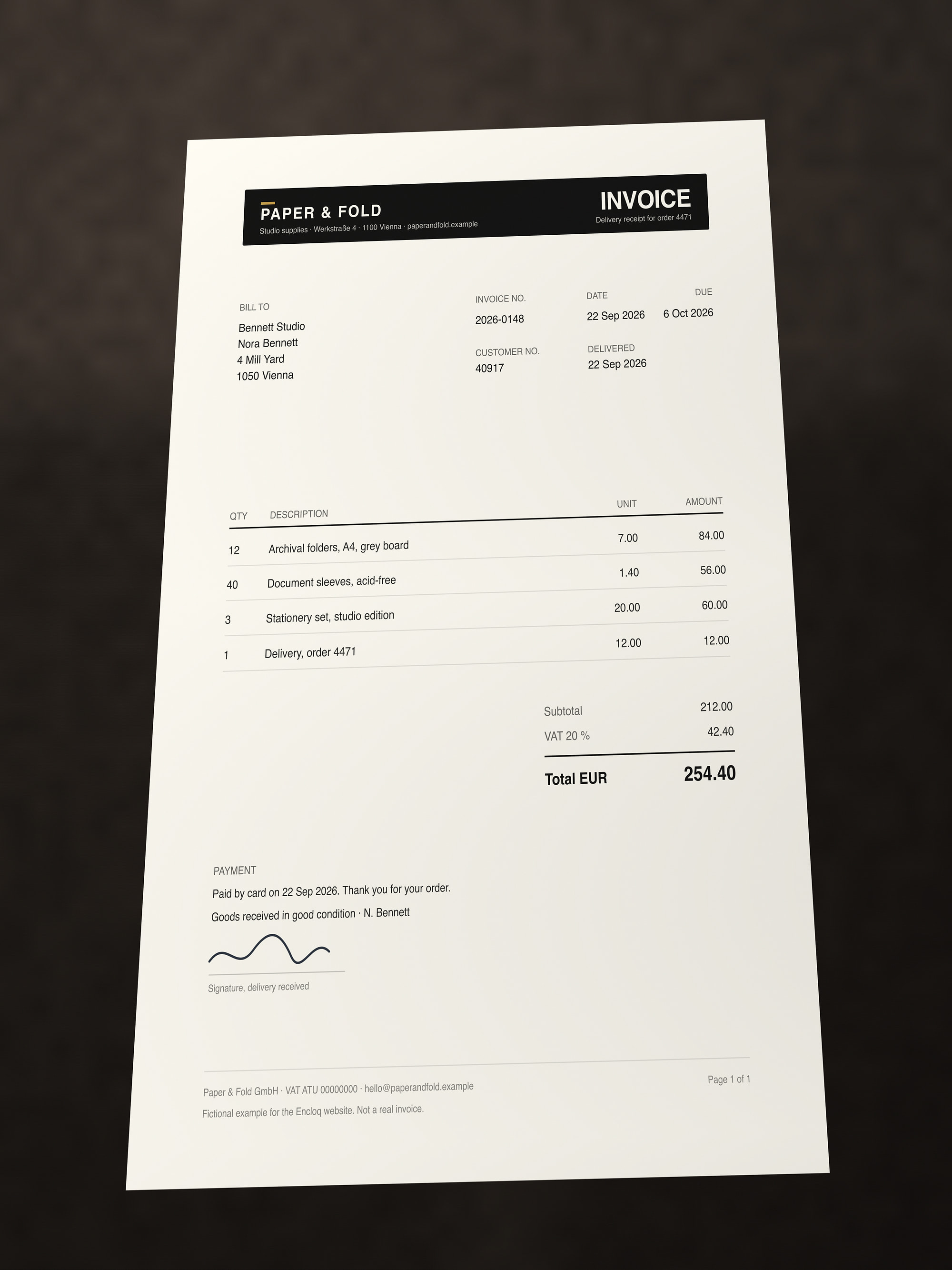 Photograph of a fictional supplier invoice lying on a dark desk